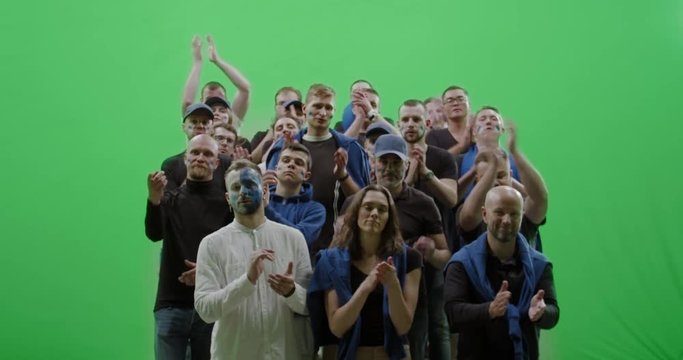 GREEN SCREEN CHROMA KEY Front view group of people fans wearing blue clothes watching a sport event. 4K UHD ProRes 422 HQ