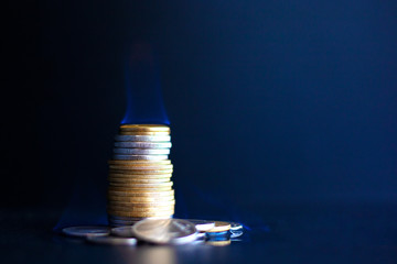 Concept money runs out quickly,metal coins burn with a blue flame
