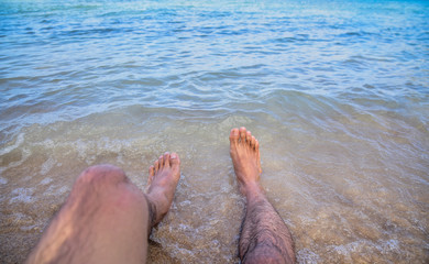 Man Sitting on Sand at beach sea