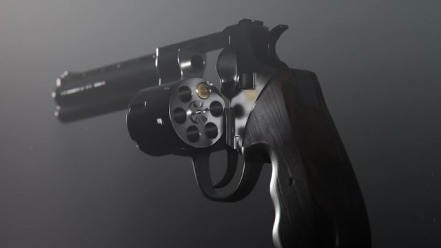Revolver with spinning cylinder holding one bullet. Playing russian roulette.