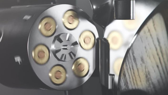 Revolver spinning cylinder holding six cartridges. Close up. Ready to shoot.
