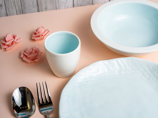 Round, square, oval white, blue, grey plate on pink, wooden, blue background, top view
