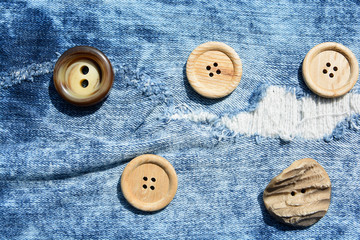 Texture of worn denim fabric with multi-colored sewn buttons for backgrounds.Jeans