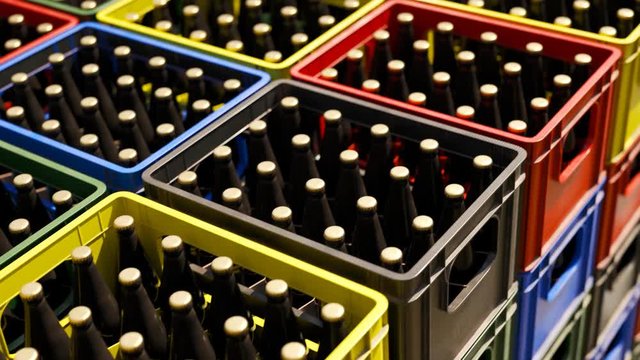 Loop of countless colorful beer crates stacked in an outdoor warehouse. 4KHD