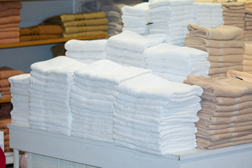 Clean White Towels and Brown Towels on shelf