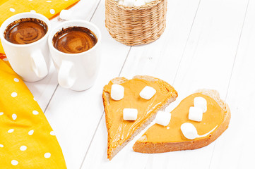 Peanut butter sandwiches. Breakfast, coffee and bread with peanut butter