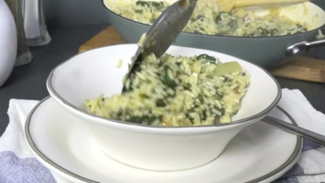 Serving homemade spanakorizo, a Greek rice and spinach dish