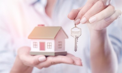 House in human hand on  background