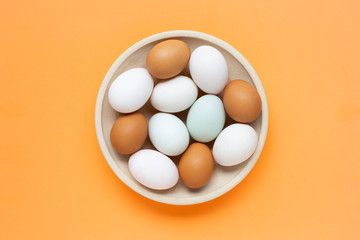 Eggs on orange background.