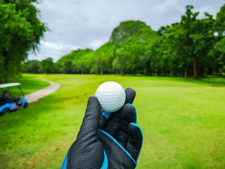 golf ball in the golfer's hand at the golf course in Thailand