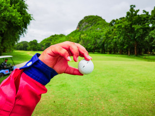 golf ball in caddy's hand at the golf course in thailand-1.jpg