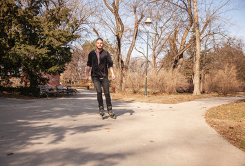 Fototapeta premium one young man, inline skating in a park outdoors.