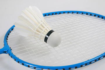 Close up shuttlecock on racket badminton on white background