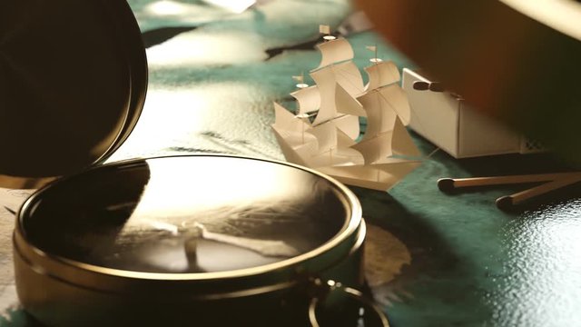 Tiny little paper ship navigating through a sea on an old treasure map. 4KHD