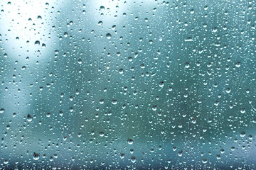  wet glass during rain. blue wet background