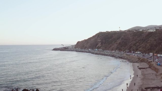 Aerial drone shot, over Malibu beach Pacific Coast Highway with traffic of cars