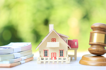 Property auction, Gavel wooden and model house on natural green background, lawyer of home real estate and ownership property concept