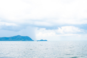Background image of a beautiful sea horizon with clouds above it in Thailand.