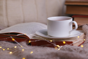 still life a cup of tea with an open book on a wooden table, the concept of coziness and reading, Cozy autumn winter leisure time