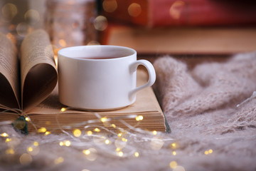 still life a cup of tea with an open book on a wooden table, the concept of coziness and reading, Cozy autumn winter leisure time