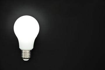 LED light bulb on black background, concept of ideas, creativity, innovation or saving energy, copy...