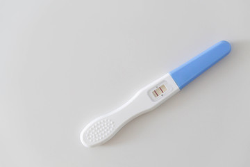 Pregnancy test on white ceramic background, health care and medical concept