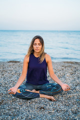 Young healthy Yoga woman practicing yoga pose on the beach at sunrise, benefits of natural environments for physical, spiritual, healthy, relaxing concept.