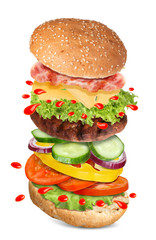 Delicious burger with different flying ingredients on white background