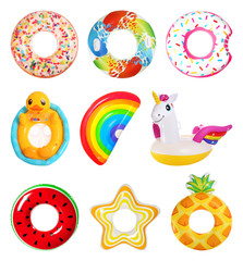 Set of bright inflatable rings and mattress on white background