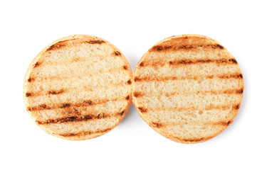 Halves of grilled burger bun isolated on white, top view