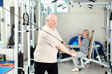 Senior patient exercising in modern rehabilitation center