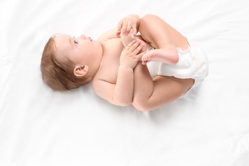 Cute little baby lying on white background, top view