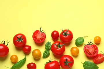 Flat lay composition with cherry tomatoes on color background. Space for text