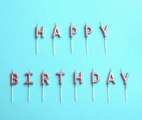 Flat lay composition with birthday candles on color background