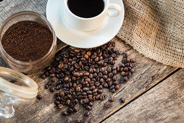 Coffee cup and coffee beans on wooden background. Top view