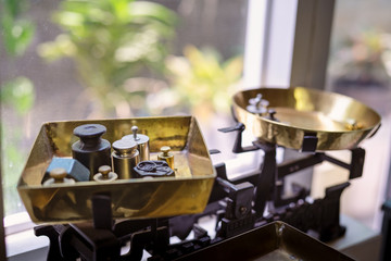 Old fashioned weights or rusty weights are on balance scale. Many kind of colorful weights used in the past. Isolated weights in vintage style with bright on background. Royalty high quality image.