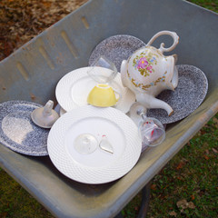 Broken dishware in a garden trolley