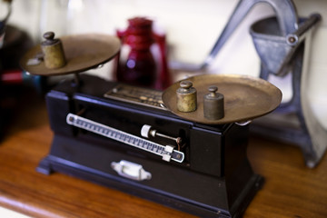 Old fashioned weights or rusty weights are on balance scale. Many kind of colorful weights used in the past. Isolated weights in vintage style with bright on background. Royalty high quality image.