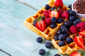 sweet belgian waffles with berries and chocolate cream