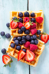 sweet belgian waffles with berries and chocolate cream