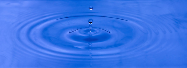 Naklejka na ściany i meble Water drop with blue colored