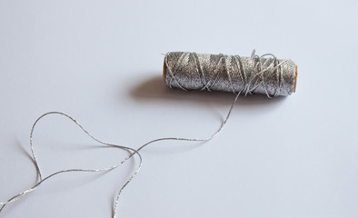 Bobbin of silver sewing.