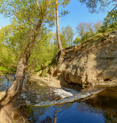 Waterfall on the river Sablinka in the village of Ulyanovsk, Leningrad region.