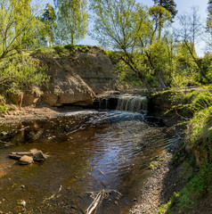 Waterfall on the river Sablinka in the village of Ulyanovsk, Leningrad region.