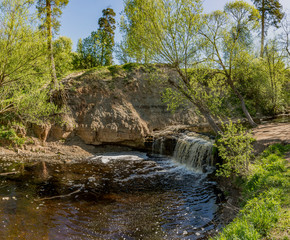 Waterfall on the river Sablinka in the village of Ulyanovsk, Leningrad region.