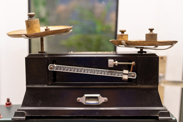 Many kind of old fashioned balance scales on wooden table. Colorful ancient balance scales in vintage background, isolated. the symbol of Lawyer. Royalty high quality free stock image.