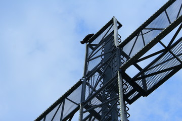 Large cross, blue sky, clouds, bird