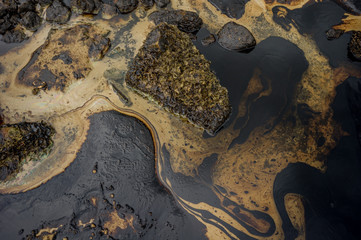 Oil sludge contaminating the sea during the oil spill disaster in Samet Island, Rayong, Thailand.