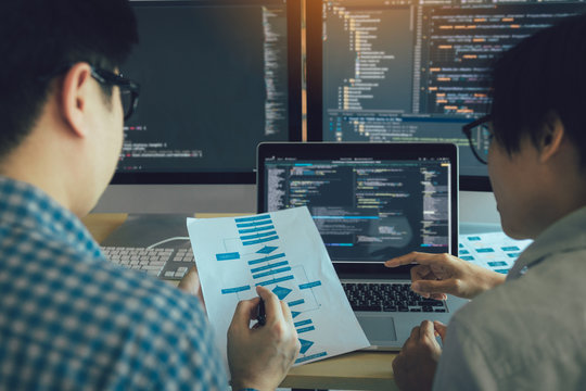 Developing programming and coding technologies working in a software engineers developing applications together in office.