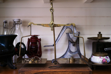 Many kind of old fashioned balance scales on wooden table. Colorful ancient balance scales in vintage background, isolated. the symbol of Lawyer. Royalty high quality free stock image.